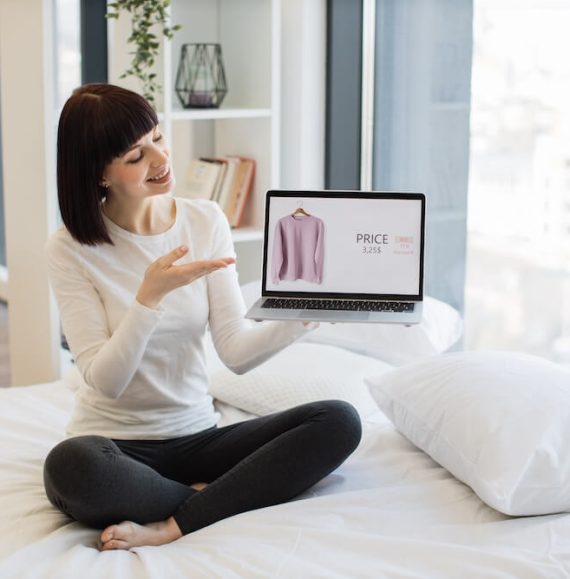 woman-holding-laptop-with-online-shop-of-clothes-o-2023-11-27-05-33-36-utc (1)