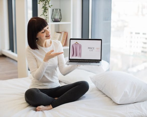 woman-holding-laptop-with-online-shop-of-clothes-o-2023-11-27-05-33-36-utc (1)